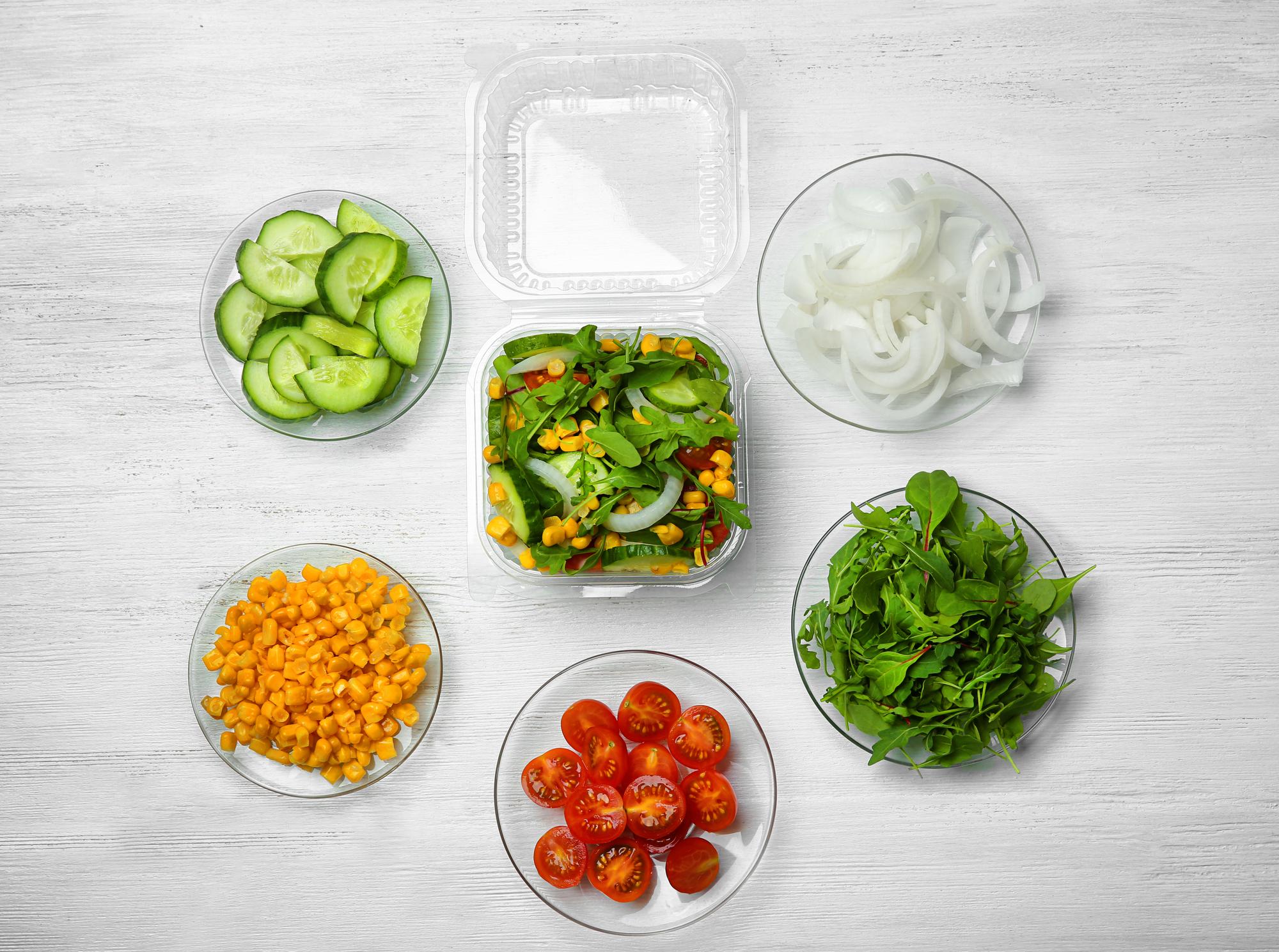 Bright salad kit components in reusable tray